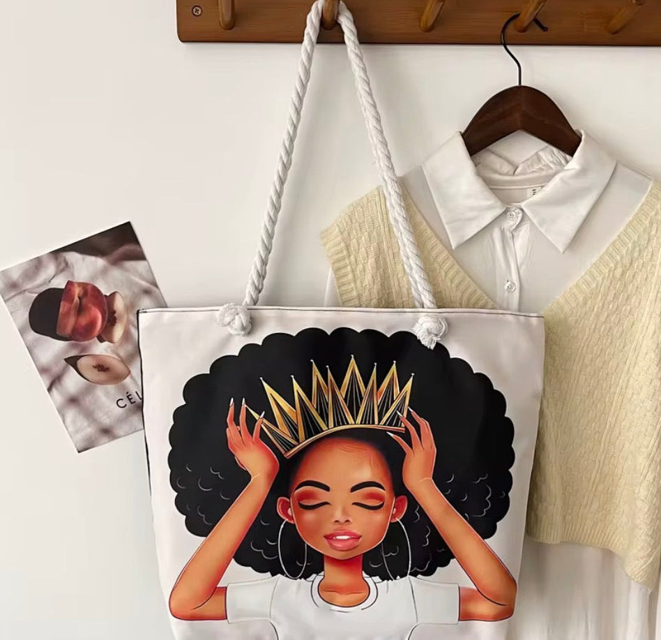 Tote bag with an illustration of a woman with a crown on a hanger with a shirt and sweater.